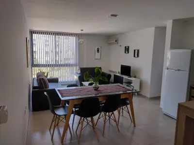 a kitchen and living room with a table and chairs at Dto a estrenar Ctro V Carlos Paz in Villa Carlos Paz