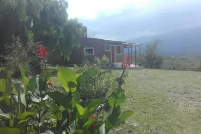 a house in a field next to a yard at fatima cabaña 4personas in Villa de Las Rosas