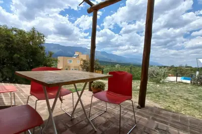 a table and chairs on a patio with a view at fatima cabaña 4personas in Villa de Las Rosas