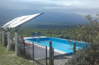 a swimming pool with a view of a mountain at fatima cabaña 4personas in Villa de Las Rosas