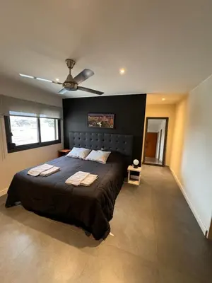 a bedroom with a large bed and a ceiling fan at MAGIC DPTO - GENERAL PAZ in Cordoba