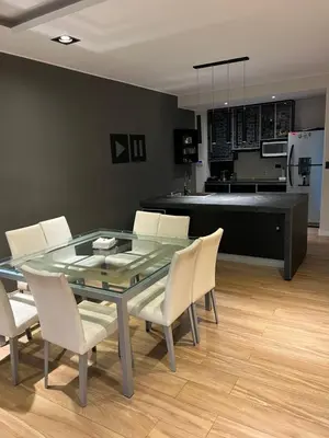a dining room with a glass table and white chairs at MAGIC DPTO - GENERAL PAZ in Cordoba