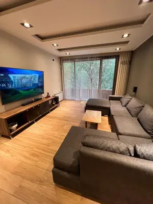 a living room with a couch and a flat screen tv at MAGIC DPTO - GENERAL PAZ in Cordoba