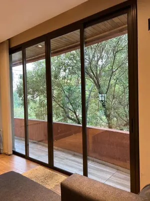 a room with sliding glass doors looking out onto a sidewalk at MAGIC DPTO - GENERAL PAZ in Cordoba
