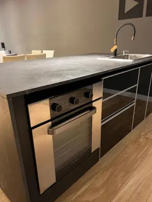 a kitchen with a counter with a stove and a sink at MAGIC DPTO - GENERAL PAZ in Cordoba