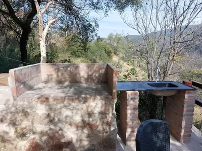 a sink in a brick wall with a view at La Soñada II in Alta Gracia