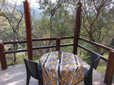 a table and chairs sitting on top of a porch at La Soñada II in Alta Gracia