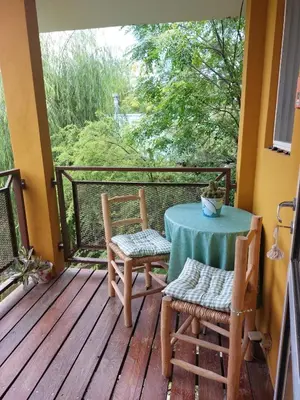 a porch with a table and chairs on a balcony at La Soñada II in Alta Gracia