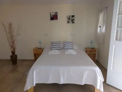 a bedroom with a white bed with two pillows at La Soñada II in Alta Gracia