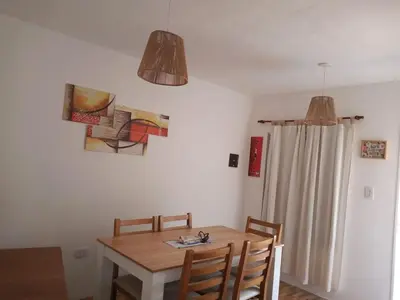 a dining room with a wooden table and chairs at La Francisca in La Carolina
