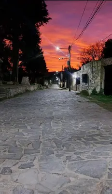 an empty street with a sunset in the background at La Francisca in La Carolina