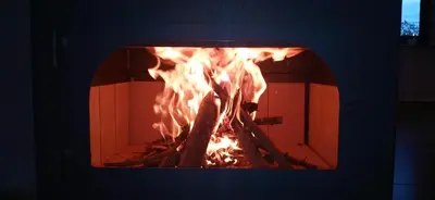a fire is burning in a brick oven at Hospedaje ideal a metros del rio in Los Reartes