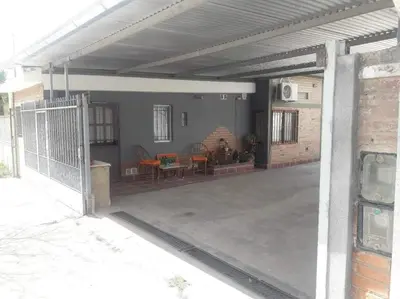 a patio with awning and a table and chairs at El Nogal monoambiente kichenete in Alta Gracia