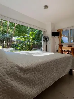 a bedroom with a large bed and a large window at Mi Universo in Villa Cura Brochero