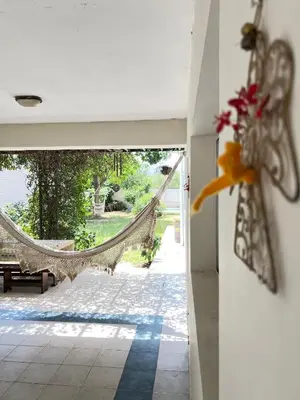 an open door to a patio with a hammock at Mi Universo in Villa Cura Brochero