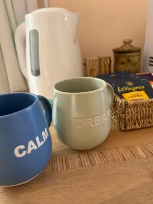 two blue and white cups sitting on a table at Mi Universo in Villa Cura Brochero