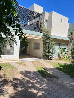 a house with a walkway in front of it at Mi Universo in Villa Cura Brochero