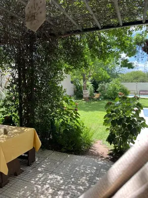a table with a yellow table cloth on a patio at Mi Universo in Villa Cura Brochero