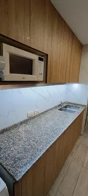 a kitchen with a sink and a microwave at Semipiso 3 Dormitorios 2 Baños Nueva Córdoba in Cordoba