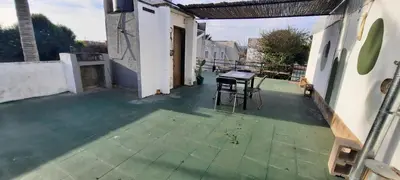 a balcony with a table and chairs on a house at Encanto Urbano vcp in Villa Carlos Paz