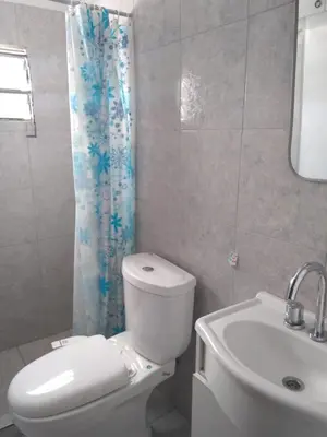 a bathroom with a white toilet and a sink at Encanto Urbano vcp in Villa Carlos Paz