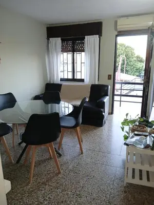 a living room with a table and chairs at Encanto Urbano vcp in Villa Carlos Paz