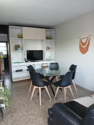 a living room with a glass table and chairs at Encanto Urbano vcp in Villa Carlos Paz