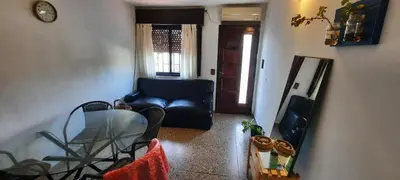 a living room with a glass table and a couch at Encanto Urbano vcp in Villa Carlos Paz