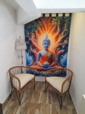 a mural in a room with two chairs at El Chañar in Villa Carlos Paz