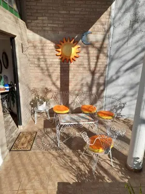 a group of chairs and a table on a patio at El Chañar in Villa Carlos Paz