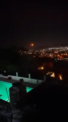 a view of a city at night at El Chañar in Villa Carlos Paz