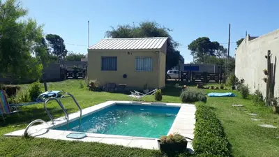 a small swimming pool in a yard with a house at WENDY Ranch in Falda del Carmen