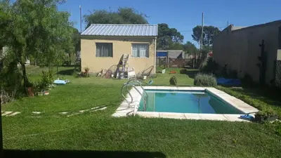 a small swimming pool in a yard with a house at WENDY Ranch in Falda del Carmen