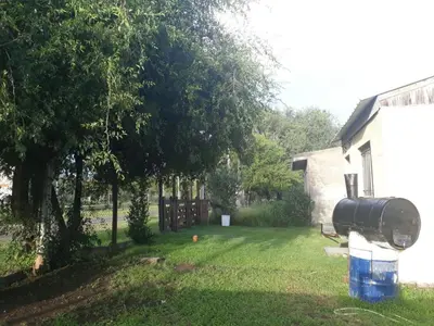 a yard with a water tank on the side of a house at WENDY Ranch in Falda del Carmen