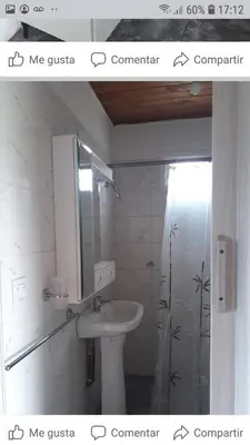 a white bathroom with a sink and a shower at WENDY Ranch in Falda del Carmen