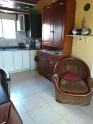 a kitchen with a chair in the middle of a room at Mi lugar in Villa Carlos Paz