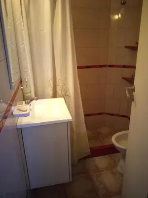 a bathroom with a white sink and a toilet at Mi lugar in Villa Carlos Paz