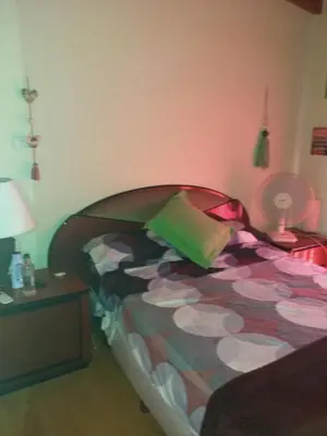 a bedroom with a bed and a table with a lamp at Mi lugar in Villa Carlos Paz