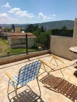 a blue chair sitting on top of a balcony at Mi lugar in Villa Carlos Paz