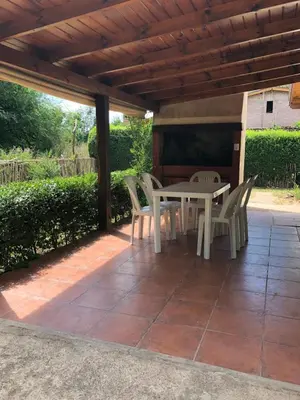 a patio with a table and chairs under a pergola at Los Manzanos in Villa Ciudad Parque