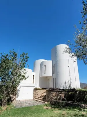 two white buildings with a blue sky in the background at Mediterránea Casa Vacanza in Villa Carlos Paz