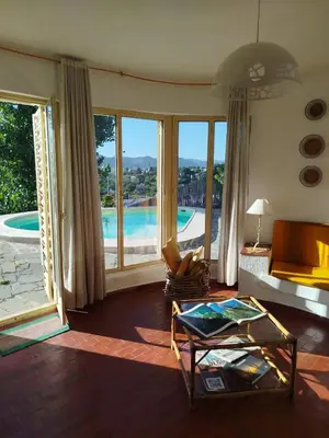 a living room with a view of a pool at Mediterránea Casa Vacanza in Villa Carlos Paz