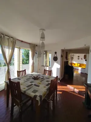 a dining room table and chairs in a room at Mediterránea Casa Vacanza in Villa Carlos Paz