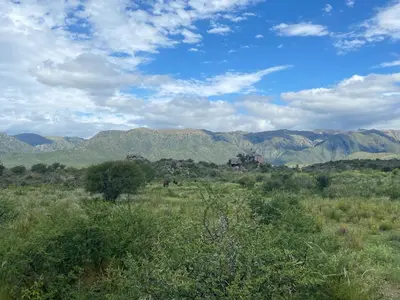 a view of a field with mountains in the background at Descanso, aventura y ecoturismo en las sierras in San Francisco del Monte de Oro