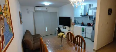 a kitchen with a dining table and a kitchen with a refrigerator at Departamento Alta Cordoba 