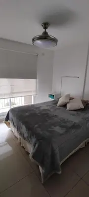 a large bed in a room with a large window at Departamento Alta Cordoba 