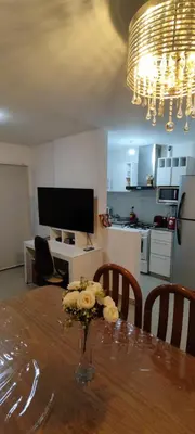 a dining room table with a vase of flowers on it at Departamento Alta Cordoba 