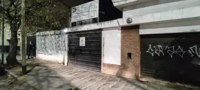 a building with a garage door with graffiti on it at Departamento Alta Cordoba 