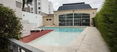 a swimming pool in front of a building at Departamento Alta Cordoba 