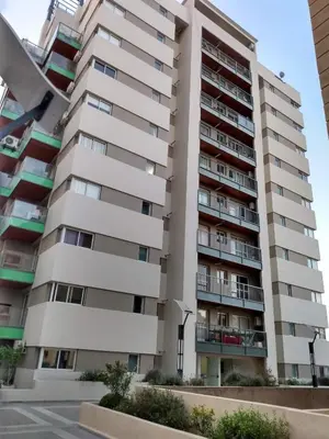 a large apartment building in front of a street at Departamento Alta Cordoba 